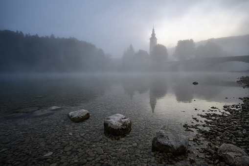 early morning fog rising on lake Bohinj