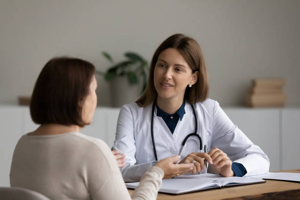 istock Happy young GP doctor examining older patient. 1341442135