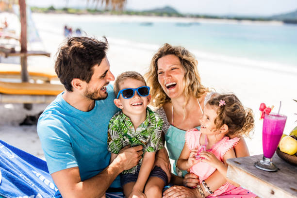istock Happy parents having fun with their kids in a beach cafe. 1341442286