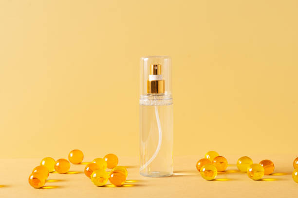 istock Serum in bottle and sphere ball capsule on yellow background 1341442329