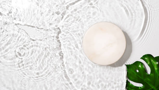 istock Transparent and clean white water background with podium and sunlight reflection 1341442340
