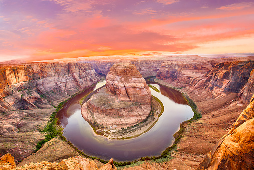 Vivid dramatic sunset over Horseshoe Bend, a famous meander on river Colorado near the town of Page. Arizona, USA