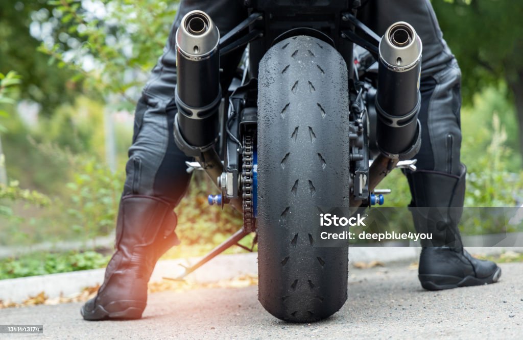Motorcyclist wants to drive with the side stand extended motorcyclist wants to drive off, but the side stand is still outMotorcyclist wants to drive with the side stand extended Motorcycle Stock Photo