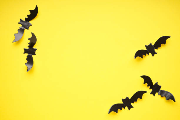 istock Halloween concept, bats on a yellow background, space for text. Flat lay. 1341443198