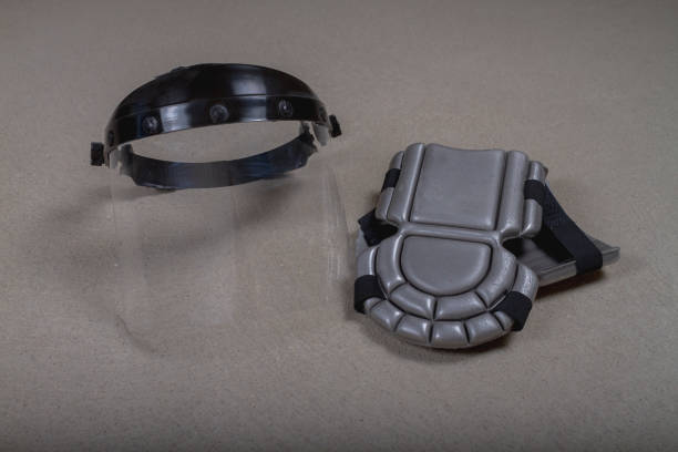 istock Protective transparent eye mask, soft knee pads for a construction worker 1341444720