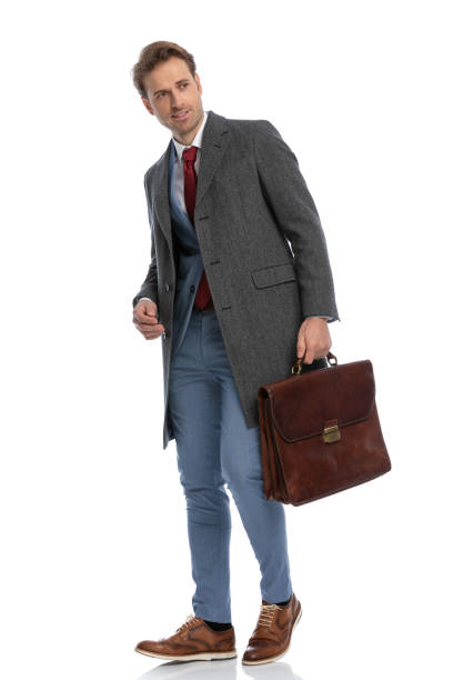 istock handsome elegant man with jacket and suitcase looking to side 1341445278