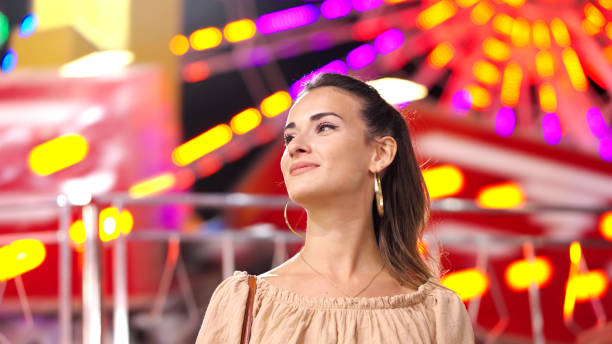 istock Young woman in amusement park 1341446473