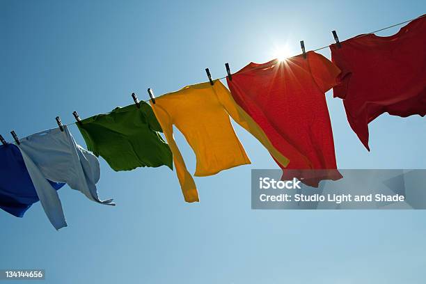 Sun Shining Over A Laundry Line With Bright Clothes Stock Photo - Download Image Now