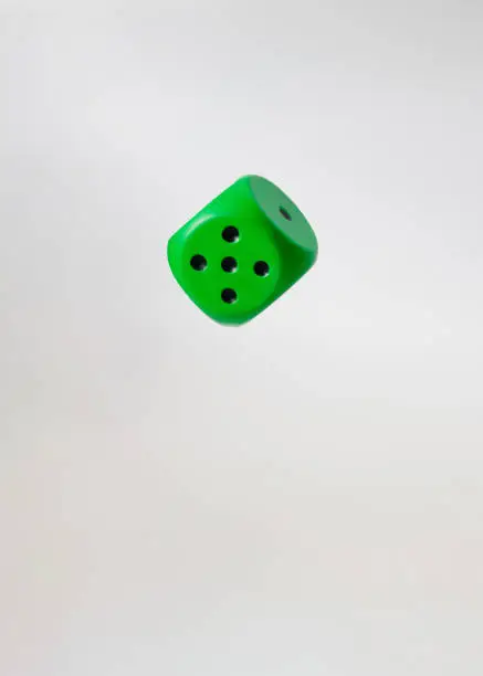 Photo of flying object green dice.hazard concept idea
