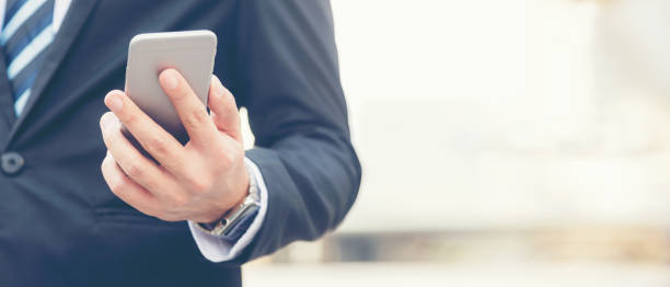 istock Close up hand Businessman using smart phone communication him work.  People partner man check data financial in tablet computer.  Business and Technology Concept. copy space for banner 1341450925