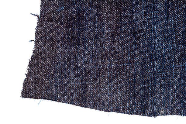 Piece of blue jeans fabric Piece of blue jeans fabric isolated on white background. Rough uneven edges. Denim pants torn. fabric edge stock pictures, royalty-free photos & images
