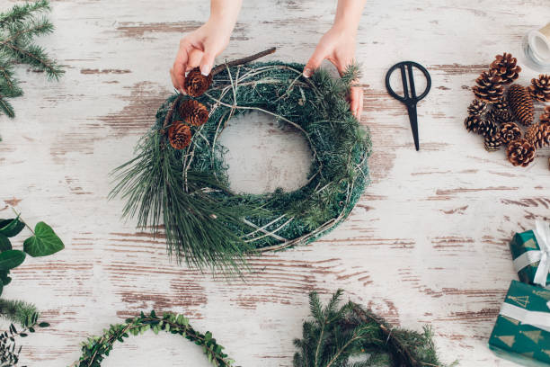 istock Woman Making A Christmas Wreath 1341451290