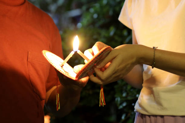 An Asian couple are enjoying decorating garden with lanterns.
