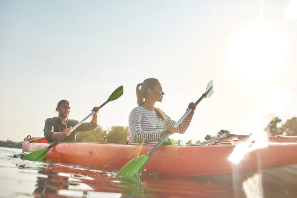 istock Young couple spending weekend together kayaking in a boat on a river on a summer day 1341455910