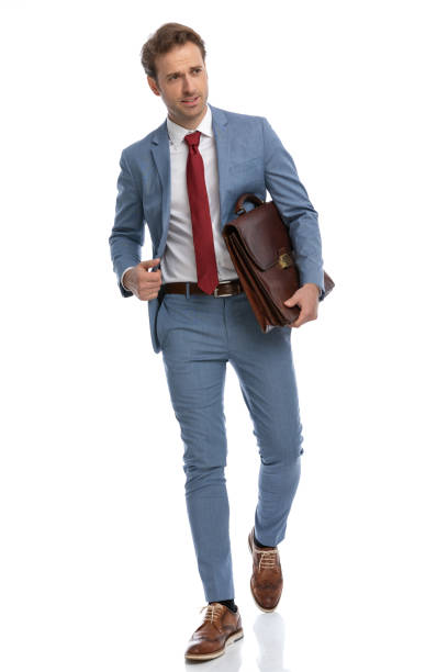 istock attractive young man in blue suit looking to side and holding briefcase 1341456345