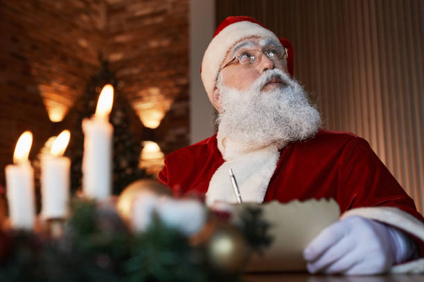 istock Pensive Santa Writing Letter 1341457808