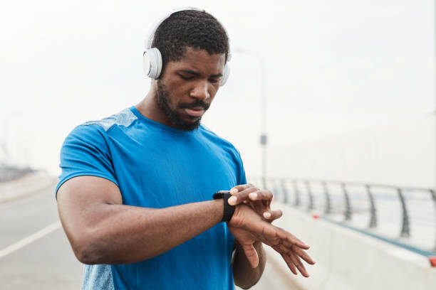 istock Athlete examining his pulse on fitness bracelet 1341458024