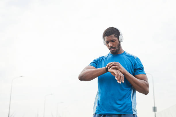 istock Man using fitness bracelet during training 1341458030