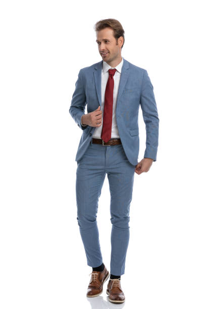 istock sexy elegant man with red tie looking to side and fixing suit 1341458141