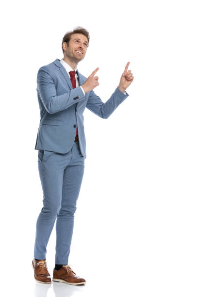 istock young businessman looking up and pointing finger up and walking 1341458334