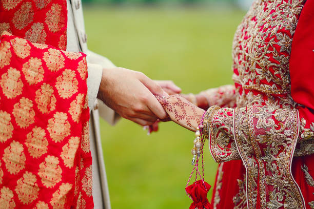 istock hindu bride walks behind husband holding garb 1341459067