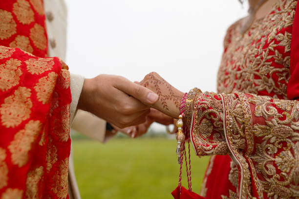 istock hindu bride walks behind husband holding garb 1341459078