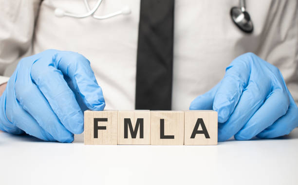 istock cubes with the word fmla on doctor's hand. Care concept. 1341459121