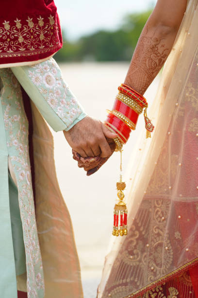 istock hindu bride walks behind husband holding garb 1341459157