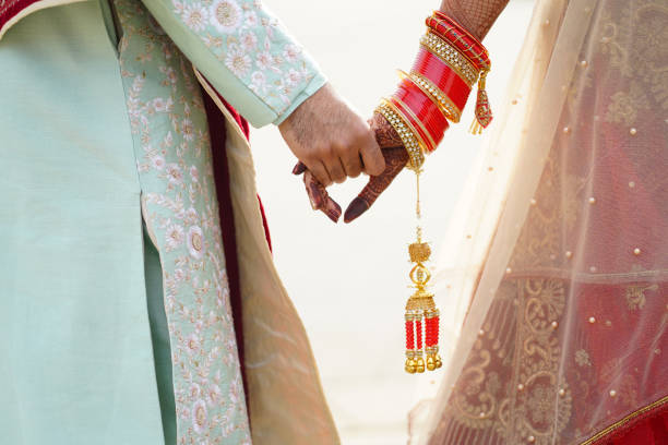 istock hindu bride walks behind husband holding garb 1341459162