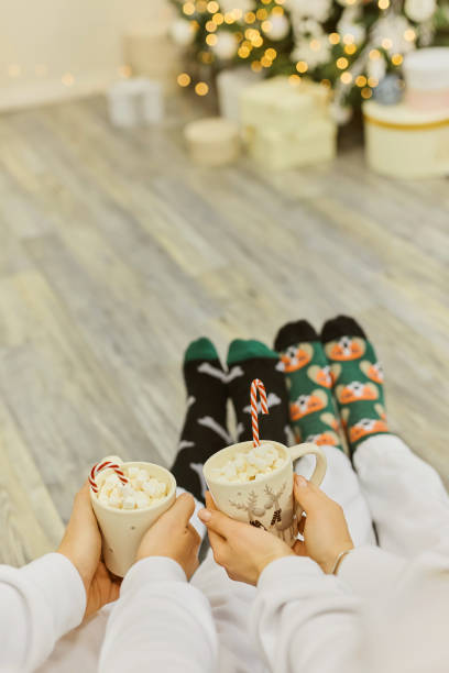 istock Feet in Santa's socks near the Christmas tree 1341459215