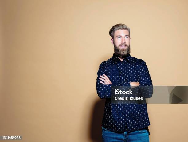 Confident Entrepreneur Standing Over Brown Background Stock Photo - Download Image Now