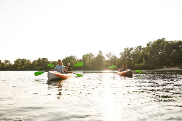 istock Enthusiastic young friends paddling together on a river, spending weekend outdoors on a summer day 1341459389