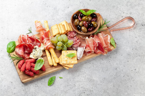 istock Antipasto with prosciutto, salami, crackers, cheese and olives 1341459972