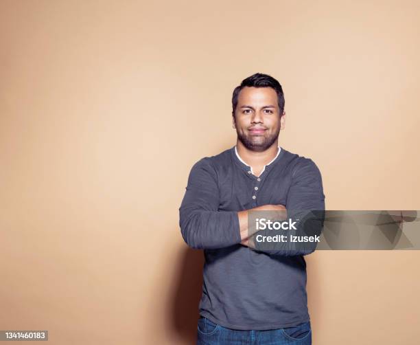Confident Man Over Brown Colored Background Stock Photo - Download Image Now - Men, Only Men, Portrait
