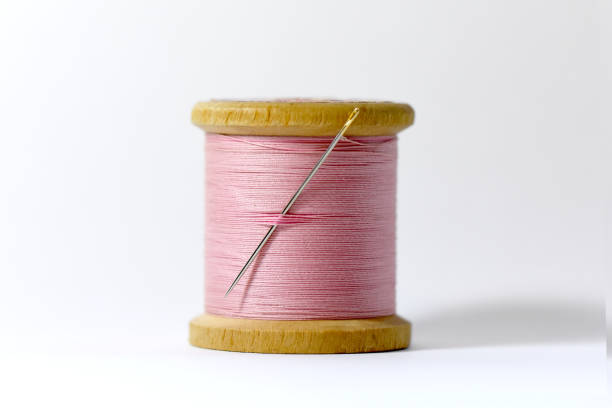 istock Pink thread bobbin pastel retro atmosphere haberdashery equipment photo 1341460310
