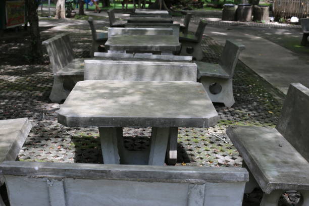 Cement table in the park with blurred background and foreground