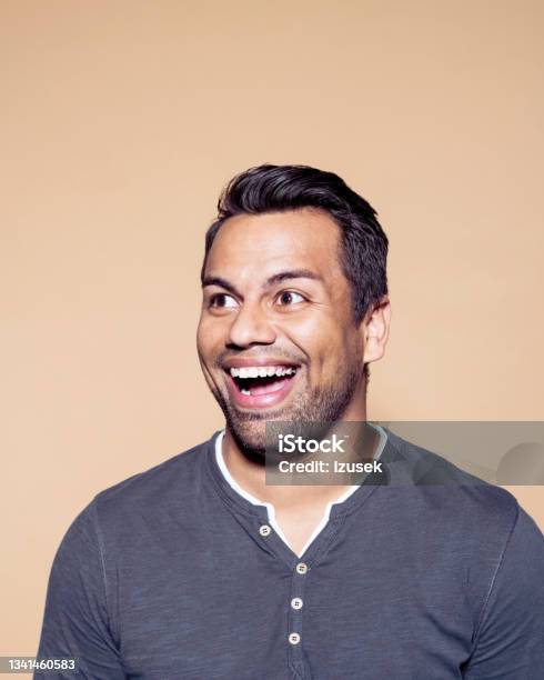 Excited Man Over Brown Colored Background Stock Photo - Download Image Now - 30-39 Years, Adult, Adults Only