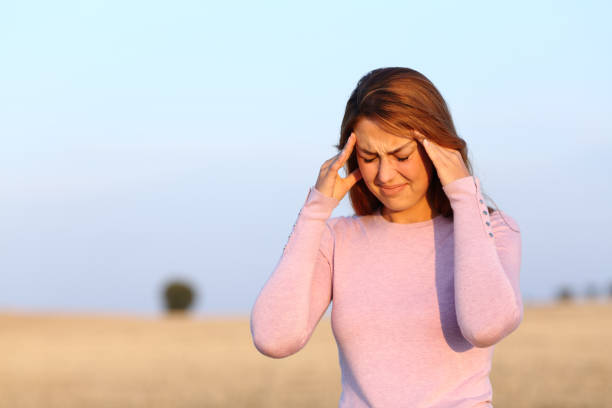 istock Woman complaining suffering headache in harvested field 1341460668