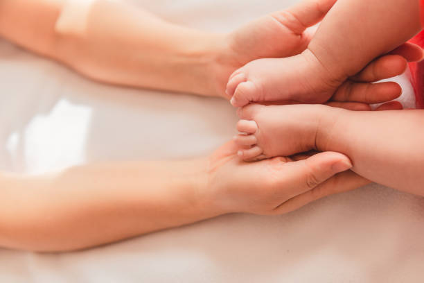 istock Newborn Foot Hold In Woman's Hand 1341461019