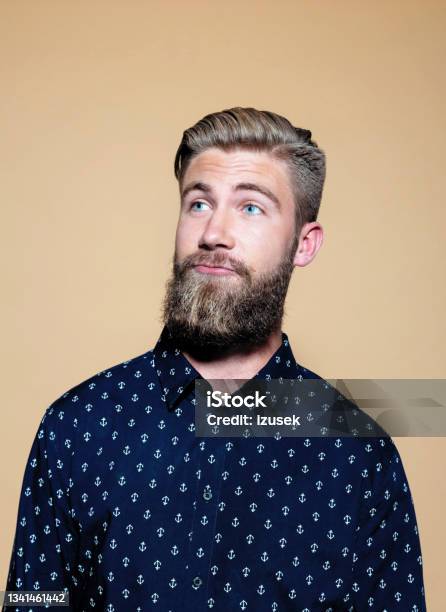 Headshot Of Surprised Bearded Young Man Stock Photo - Download Image Now - Problems, Surprise, Uncertainty