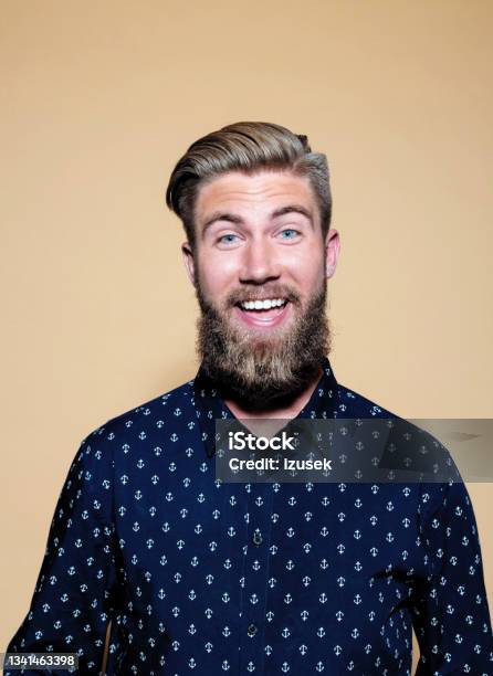 Surprised Young Man Standing Over Brown Background Stock Photo - Download Image Now - Surprise, Happiness, Men