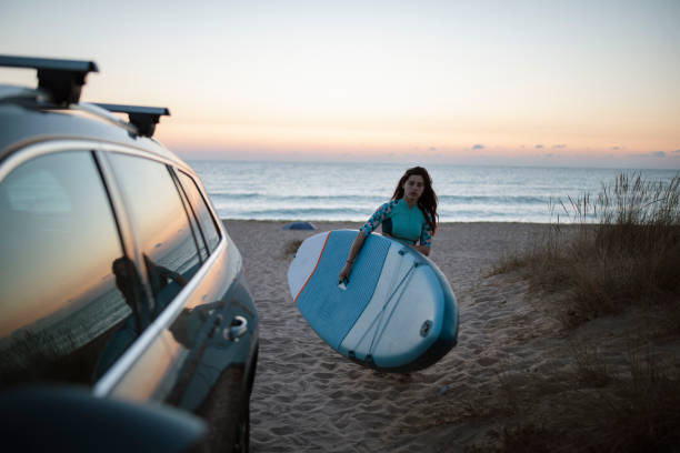 istock Woman Preparing For Surfing At Sunrise. 1341467694