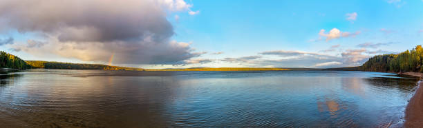 istock lake after rain with a rainbow over it on a summer evening 1341469225