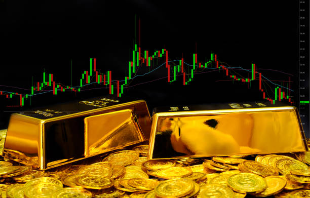 istock Gold bullion on pile gold coins at trading chart background 1341469384