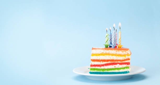istock Birthday cake with burning candles on a blue 1341470516