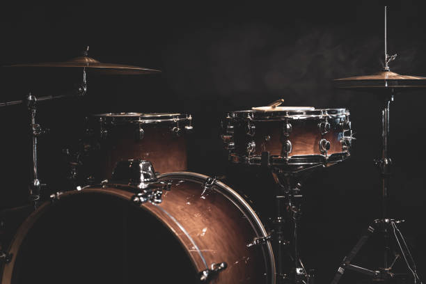 istock Drum kit on a dark background with stage lighting, copy space. 1341474081