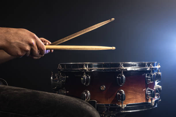 istock A man plays with drumsticks on a snare drum, close up. 1341474082