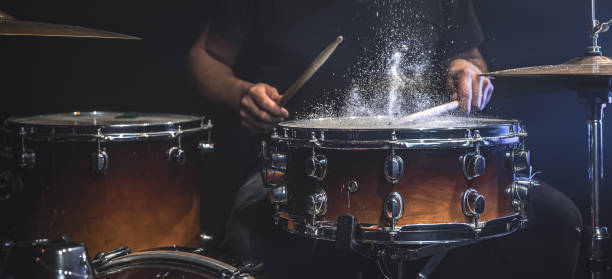 istock The drummer plays the snare drum with splashing water. 1341474089