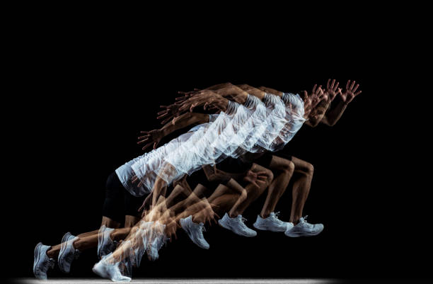 istock Young male professional athlete running, training isolated over black studio background. Stroboscope effect 1341474111