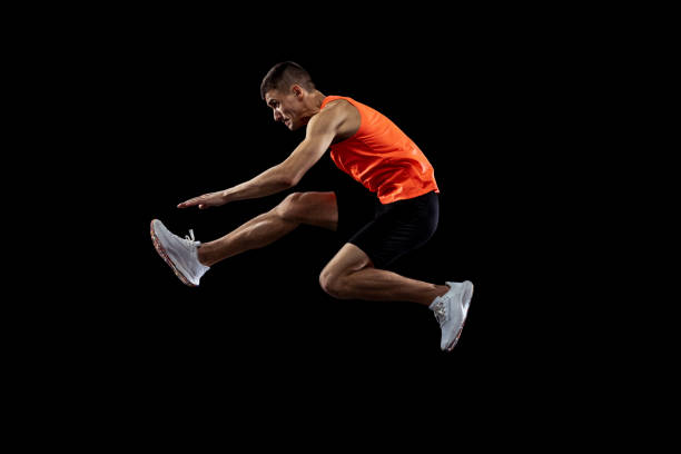 istock Young man, male athlete in motion isolated over black studio background. Side view 1341474126